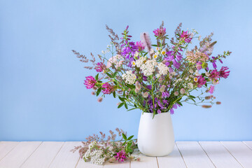 Beautiful bouquet of wildflowers in a white vase