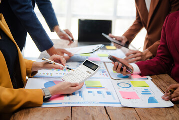 Business people meeting at office writing notes about sticky notes Laptop,tablet  Planning and Brainstorming Strategies of Colleagues