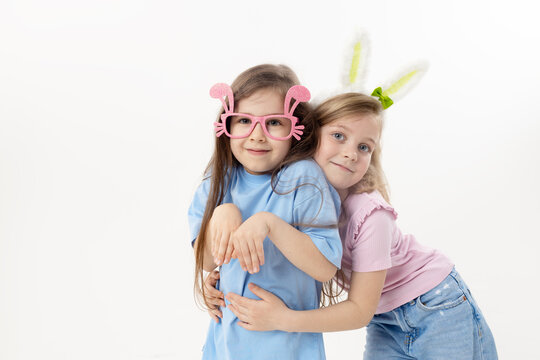 Cute little child girl wearing bunny ears glasses a on Easter day. Easter girl portrait on white background, funny emotions, surprise