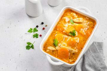 Healthy chicken goulash in ceramic dish. Top view, copy space, flat lay.