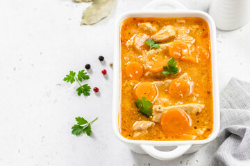 Healthy chicken goulash in ceramic dish. Top view, copy space, flat lay.