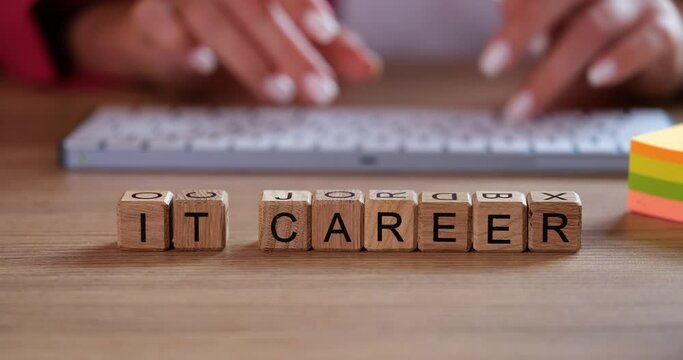 Words IT Career and IT Specialist are working on computer in background. Career and work in field of information technology