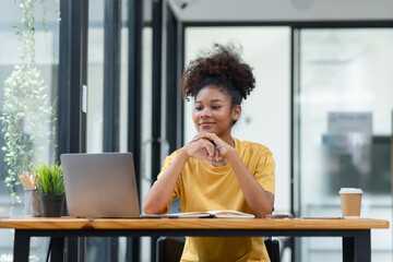 Young African American businesswoman working with pile of documents at office workplace, business finance and accounting concepts.