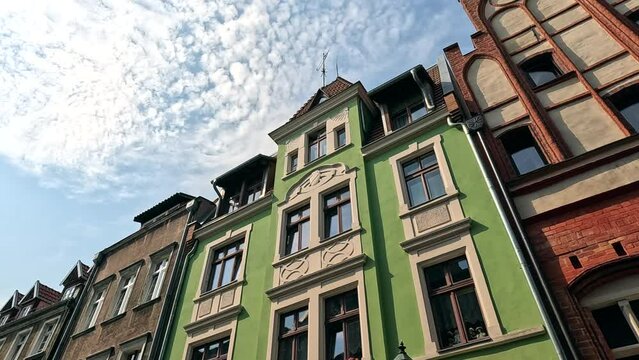 Old house in the city. Building with sky and clouds. A walk through the historic streets in the center of the old town. Old historic street. Torun, Poland.