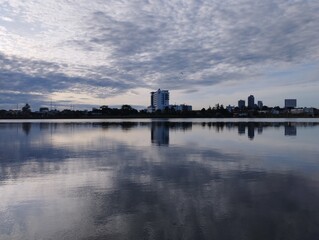 Naklejka premium city view on stormy grey cloud reflection background