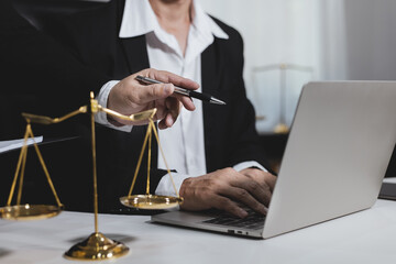 Male lawyer working with contract at desk, justice and law concept.