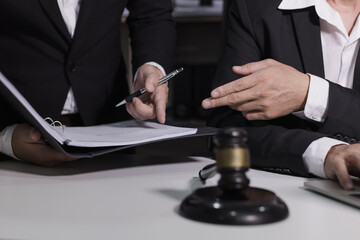 Male lawyer working with contract at desk, justice and law concept.