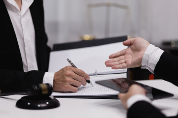 Male lawyer working with contract at desk, justice and law concept.