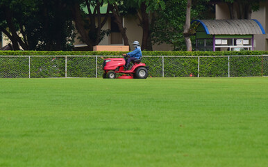 On the football field there is a lawn mower.