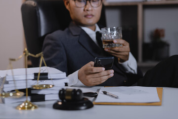 Law holding a glass of whiskey at desk, justice and law, attorney, court judge, concept.