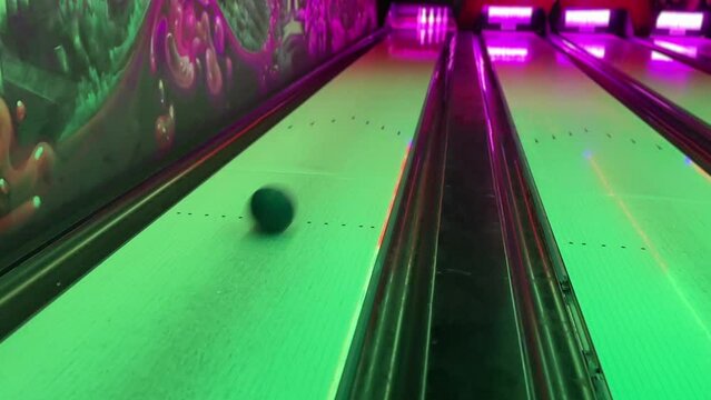 Bowling ball and pins. Bowling. View of the bowling alley and the moving ball