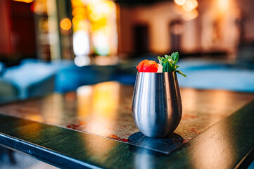 alcohol cocktail in a glass stands on a table in a bar or restaurant