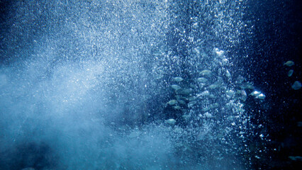 Abstract shot of sea bubbles floating up to the sea water surface from ocean bottom.
