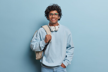 People lifestyle concept. Studio shot of young happy smiling Hindu male student standing isolated...