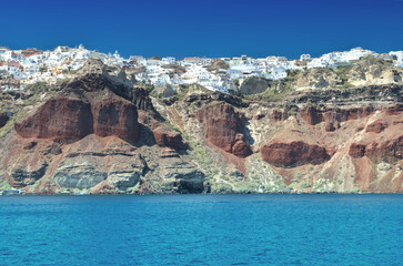 Fototapeta na wymiar Village on the top of rocky cliff Santorini island - Greece.