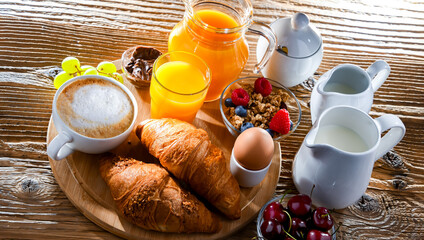 Breakfast served with coffee, orange juice, croissants and egg
