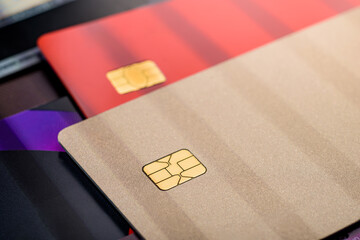 Stack of multicolored credit cards, close up view with selective focus.