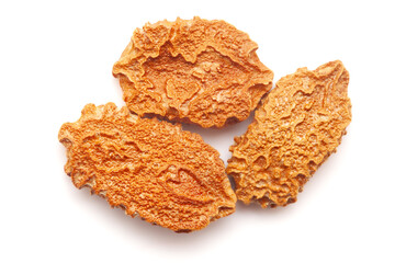 Close-up of Dried Bitter gourd or Bitter Melon (Momordica charantia) seeds isolated on white background. Top view.