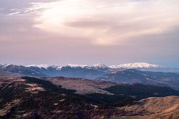 Beautiful sunset on the snow high mountains.