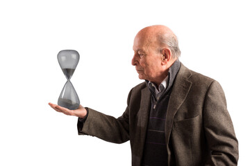 Elderly  man holds an hourglass in hand, concept of passing time