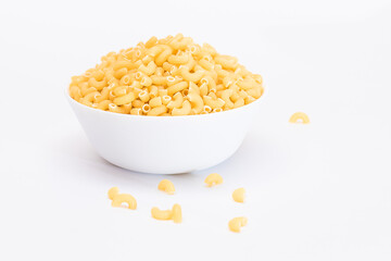 Uncooked Chifferi Rigati Pasta in White Cup Isolated on White Background. Fat and Unhealthy Food. Scattered Classic Dry Macaroni. Italian Culture and Cuisine. Raw Pasta - Isolation