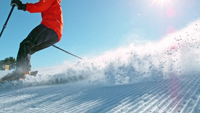 Super slow motion of piste skier running down. Filmed on high speed cinema camera, 1000fps. Speed ramp effect.
