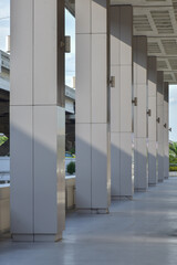 Sunlight shines on concrete pillars with sunlight reflected in building construction.