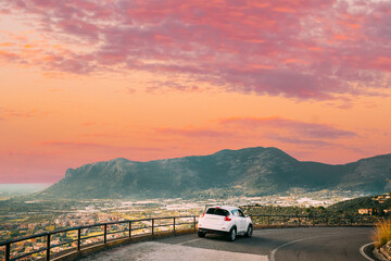 Terracina, Italy. White Color Car On Road On Background Beautiful Landscape With Mountains In Italy