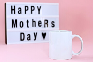Blank mug with Happy Mother's Day led light box on pink background. 11 oz mug mockup