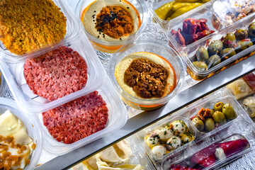 Variety of prepackaged food products in plastic boxes