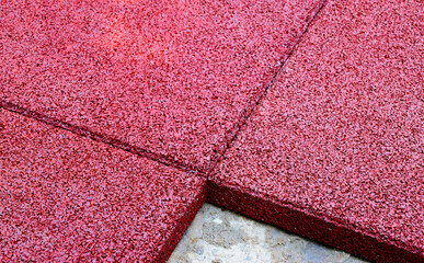 padded granular soft rubber safety and sport floor. play surface. square tiles on concrete. kids...