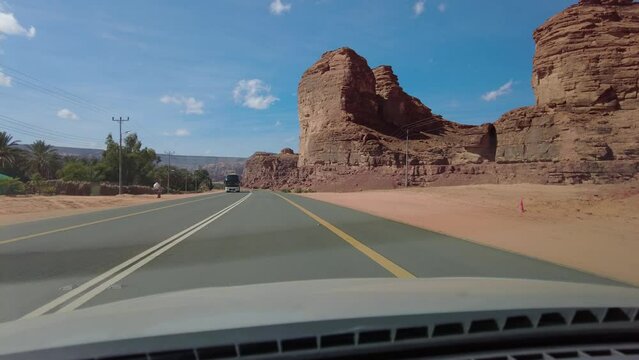 Al Ula, Saudi Arabia: Point of view of a car driving on the road through the Al Ula area, famous for its archeological sites in the desert of Saudi Arabia. 