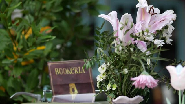 Mechanical military Bisel semi-portable typewriter. Pot of pink flowers. Restaurant advertising vintage accessory. Eye catcher. Props to attract customers. Cozy resort. Rovinj, Croatia - July 7, 2023