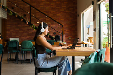 Smart young woman using the internet zone working at a cafe