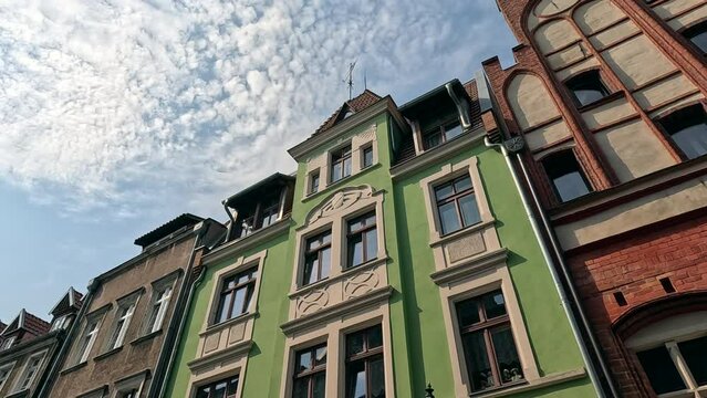 Old house in the city. Building with sky and clouds. A walk through the historic streets in the center of the old town. Old historic street. Torun, Poland.