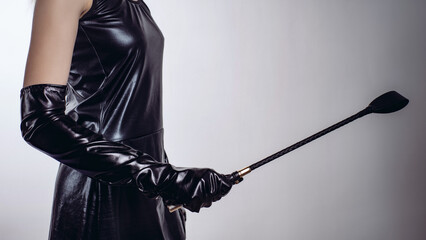 Sexy Lady Holding Strict Leather Short Handle Wide Head Riding Crop