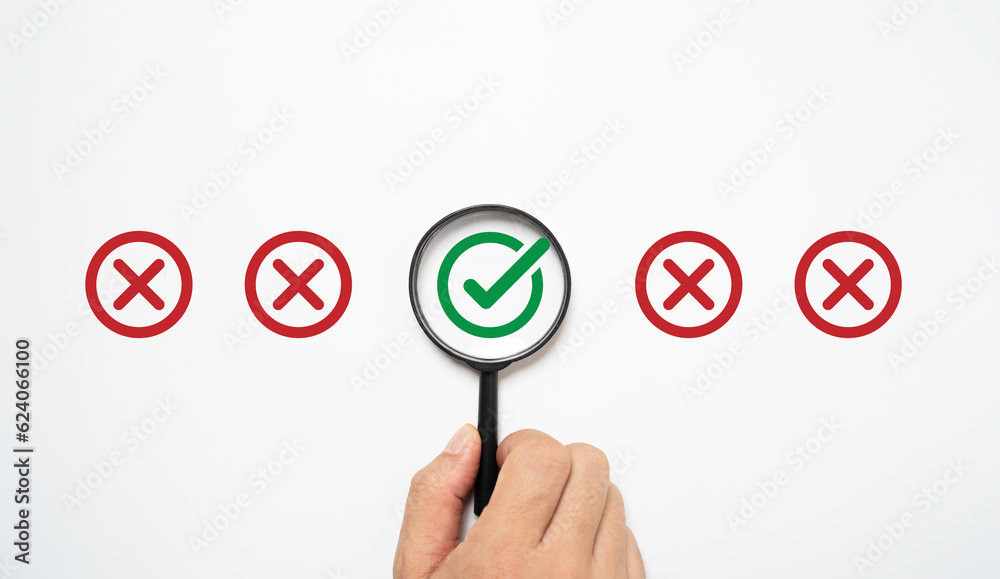 Poster hand holding magnifier glass with green correct sign mark among red incorrect symbol for approve doc