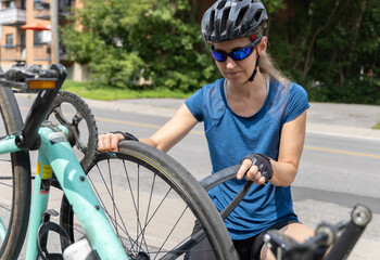 Woman repairing flat tire on a bicycle