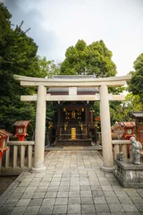 Gordijnen Japanese Torii gate in Kyoto. Traditional shrine gate near temples in a forest in Japan © Benoît