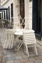 Fototapeta na wymiar Chairs and tables stacked in a closed cafe