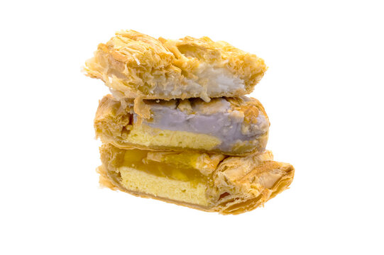 pineapple pie  and taro pie and coconut pie stacked in a pile on white background closeup