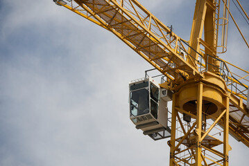 View of a construction site crane and the operator's cab