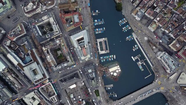 Zurich, Switzerland: Overhead drone footage of the Limmat river in Zurich medieval old town and business and financial district in Switzerland largest city in the evening. 