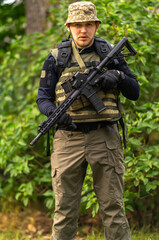 Fototapeta premium Young man in military uniform with a AR