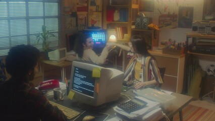Cheerful young woman successfully finishing work on computer detail doing high five and fist bump with her male colleagues, 90s aesthetics - Powered by Adobe