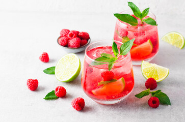 Refreshing Cold Cocktail or Mocktail with Berries and Lime, Raspberry Lemonade