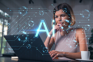 Thoughtful businesswoman in casual wear typing on laptop at office workplace with coffee cup....
