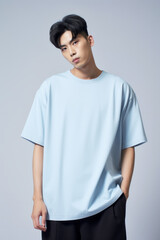 Asian man wearing plain pure light blue blank oversized crew neck loose t-shirt isolated on white background