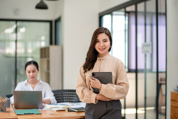 Smart asian business woman, company worker standing smile and holding digital tablet.