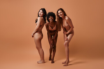 Multiethnic women on beige background